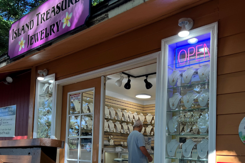 jewelry store front and sign with man shopping